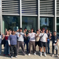 International Students Posing With Anchor UP Hand Sign in front of Laker Store Downtown